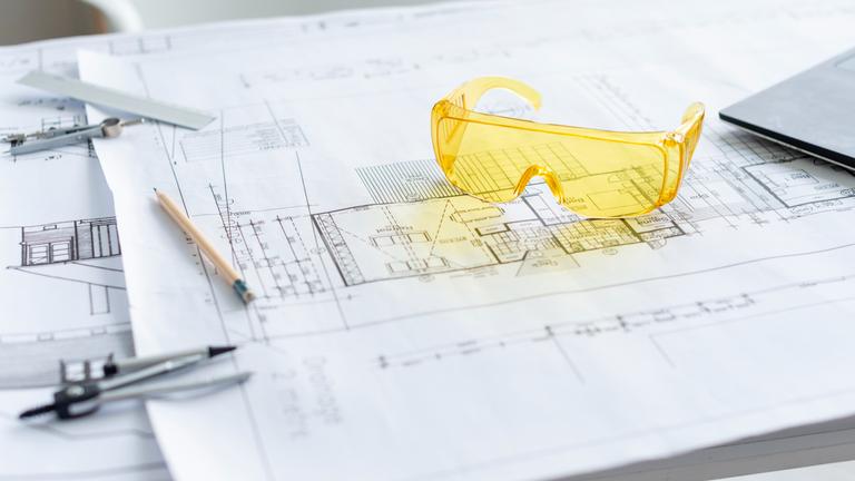 closeup-yellow-safety-glasses-architectural-project